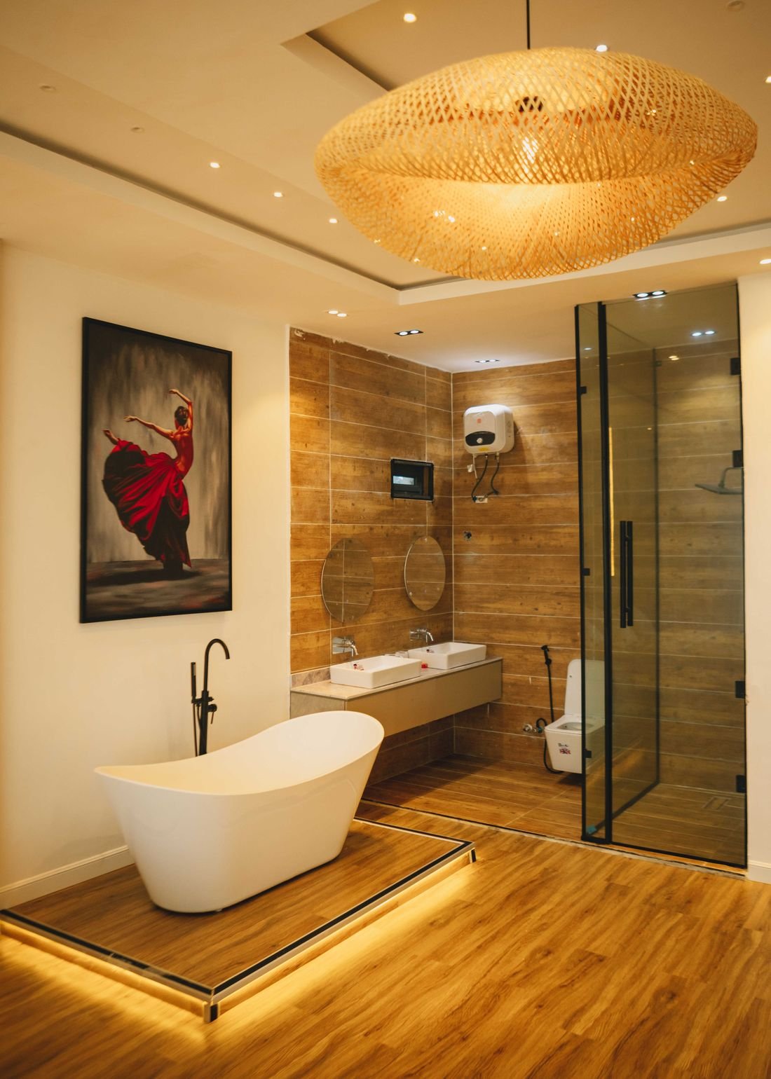 A bathroom with a freestanding tub, twin basins and a walk-in shower