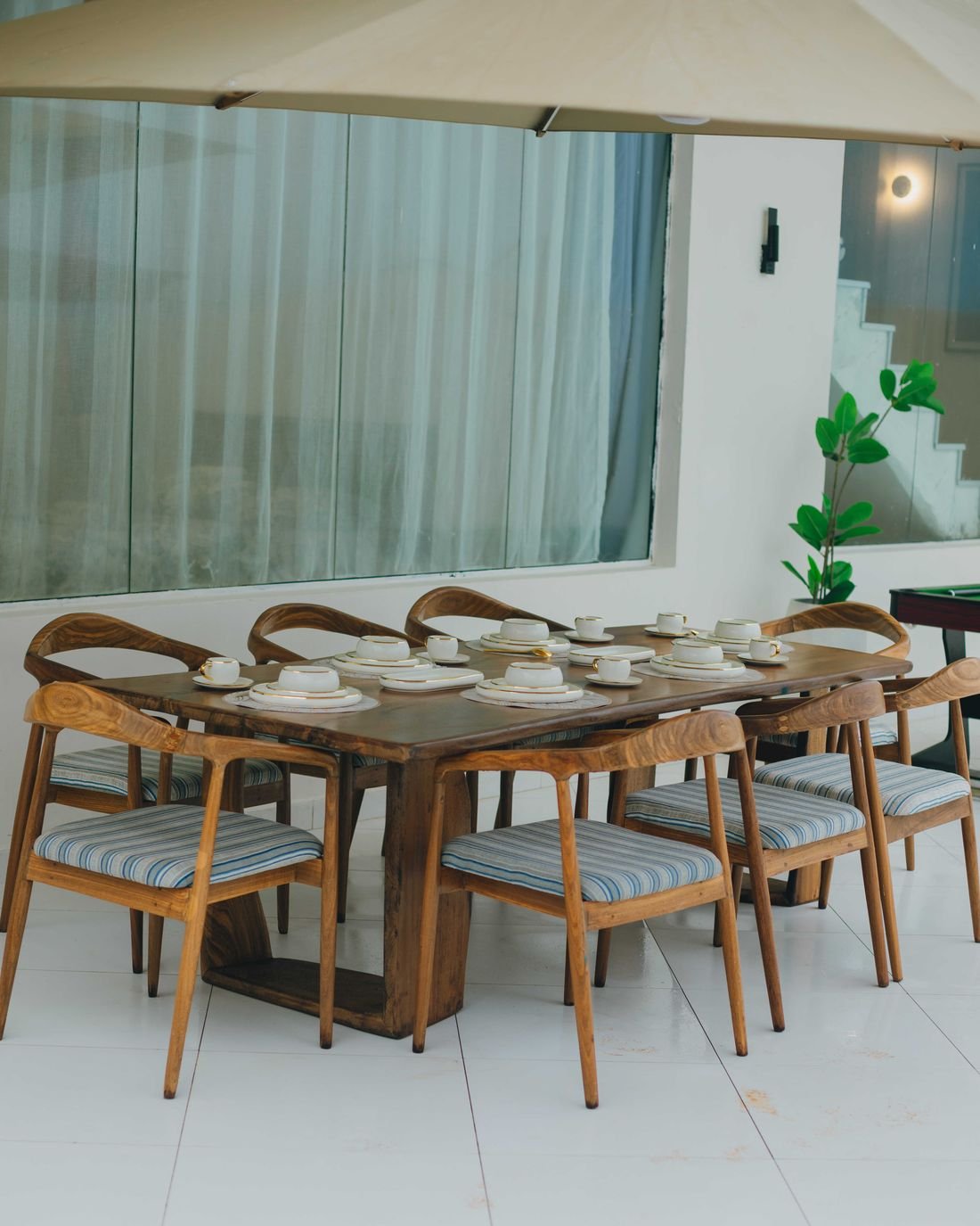The long table laid with white settings