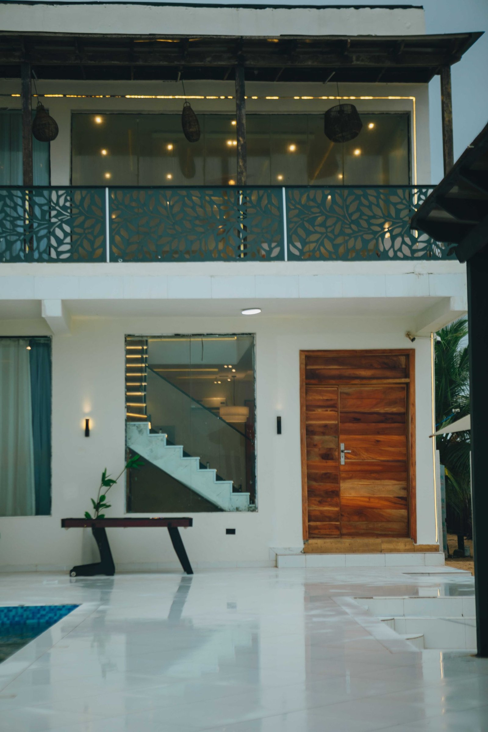 The entrance to the house, with the pool reflecting in the foreground